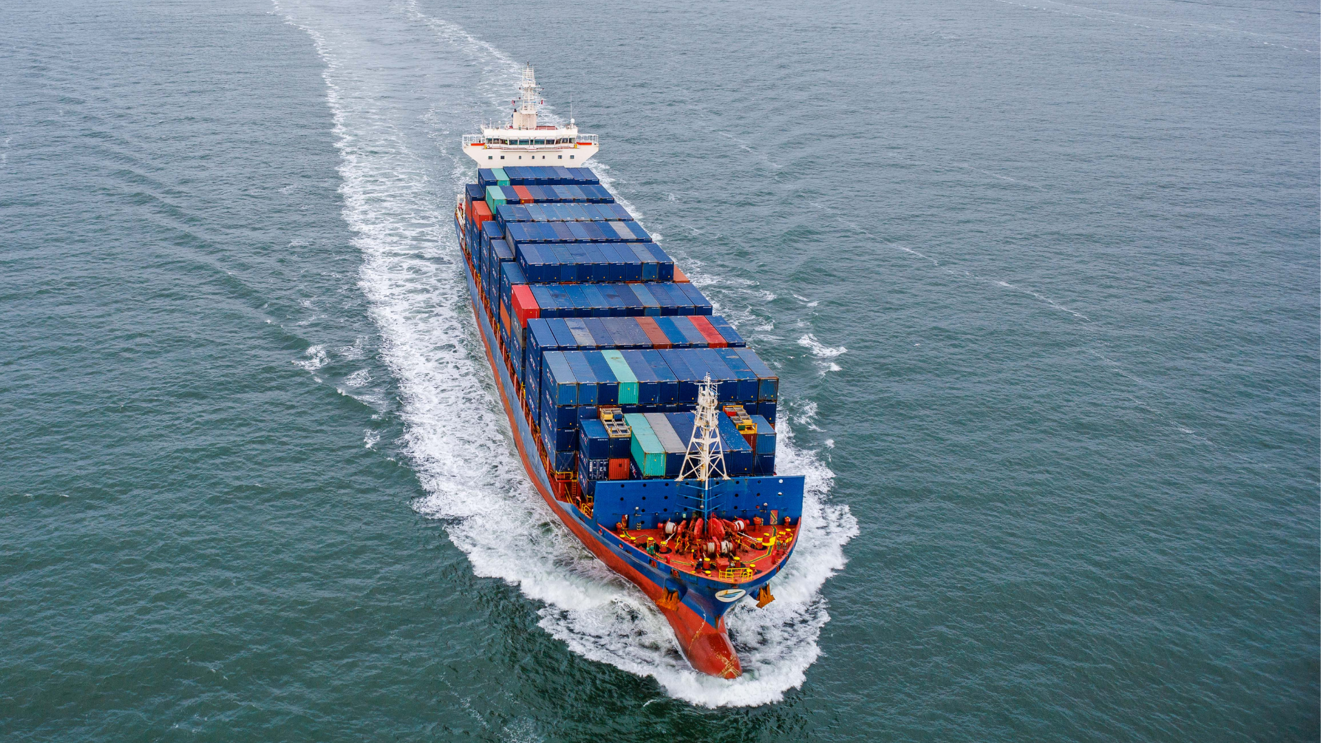 A large container ship at sea, that can run with green ammonia in future